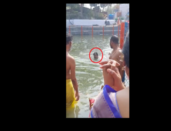 Executive Officer uses temple pond as personal swimming pool [ Telangana, India ]
